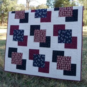 The owl blocks appear to float across the quilt
